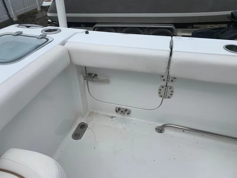 Slide: The Image of 2020 Sea Hunt Gamefish 27 Forward Seating interior, featuring white seating and stainless steel fixtures. - 6