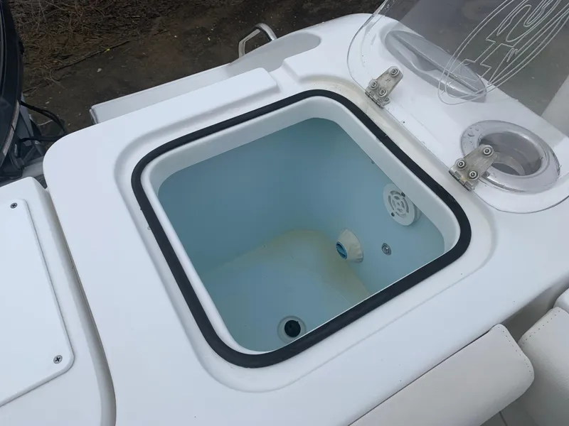 Slide: The Image of 2020 Sea Hunt Gamefish 27 livewell with open lid, showcasing interior features. - 8