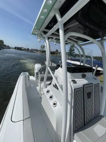 Slide: The Image of 2023 Wellcraft 242 Fisherman boat on water, showcasing sleek design and modern features. - 2