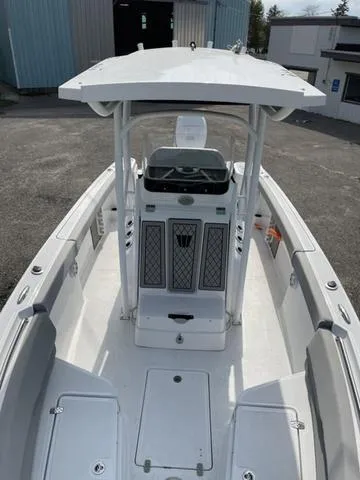 Slide: The Image of 2023 Wellcraft 242 Fisherman boat with center console and T-top in a marina setting. - 4