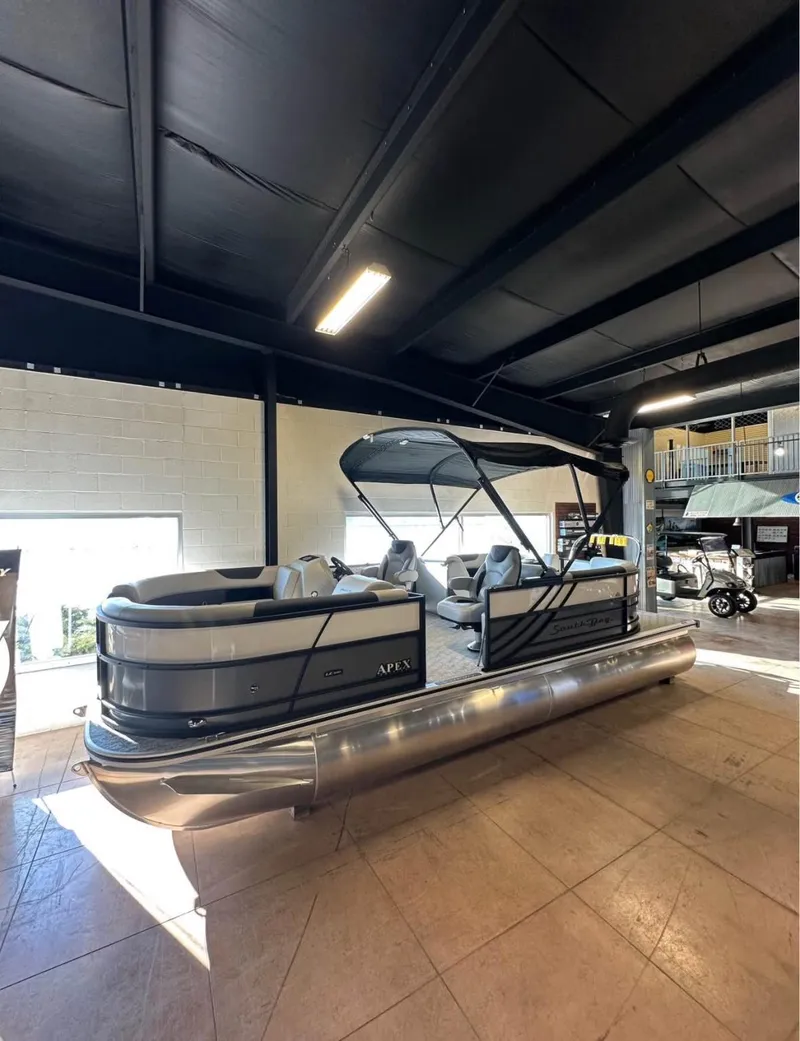 Slide: The Image of 2025 South Bay 222 RS LE Apex Edition pontoon boat displayed indoors. - 1