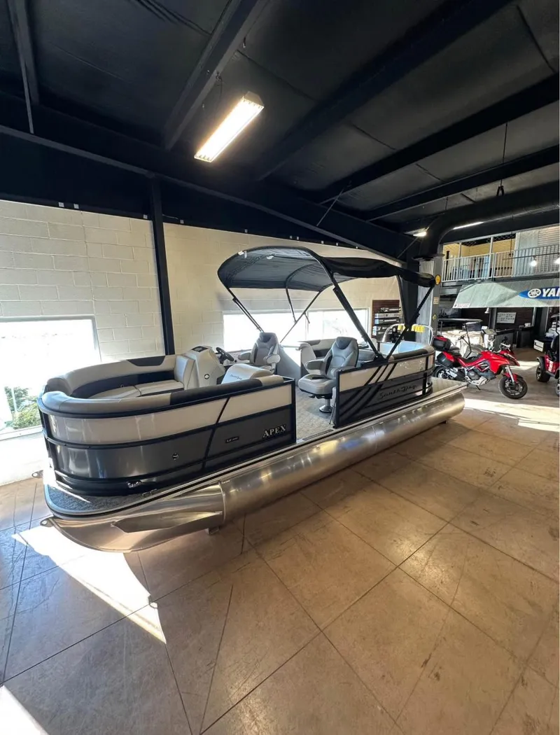 Slide: The Image of 2025 South Bay 222 RS LE Apex Edition pontoon boat displayed indoors. - 4