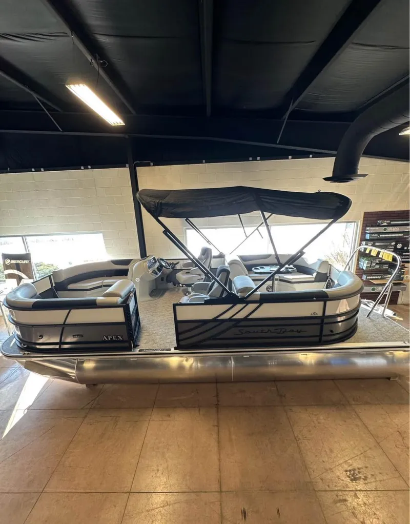 Slide: The Image of 2025 South Bay 222 RS LE Apex Edition pontoon boat with canopy in showroom. - 6