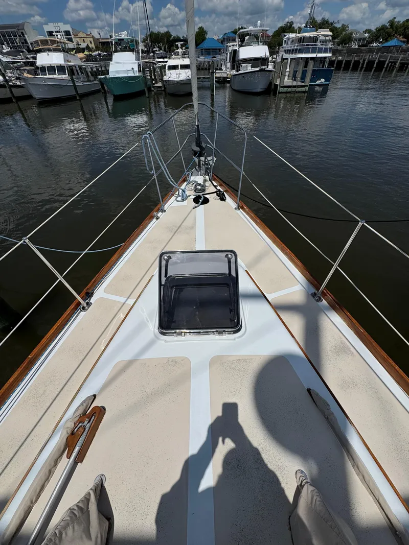 Slide: The Image of 1981 Gulfstar 44 sailboat deck view at marina with moored boats. - 10