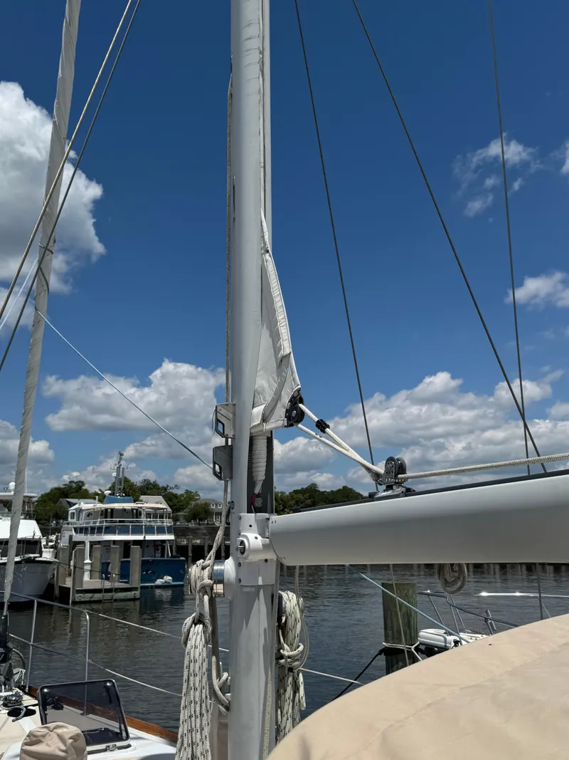 Slide: The Image of 1981 Gulfstar 44 sailboat mast and rigging at marina under clear blue sky. - 13
