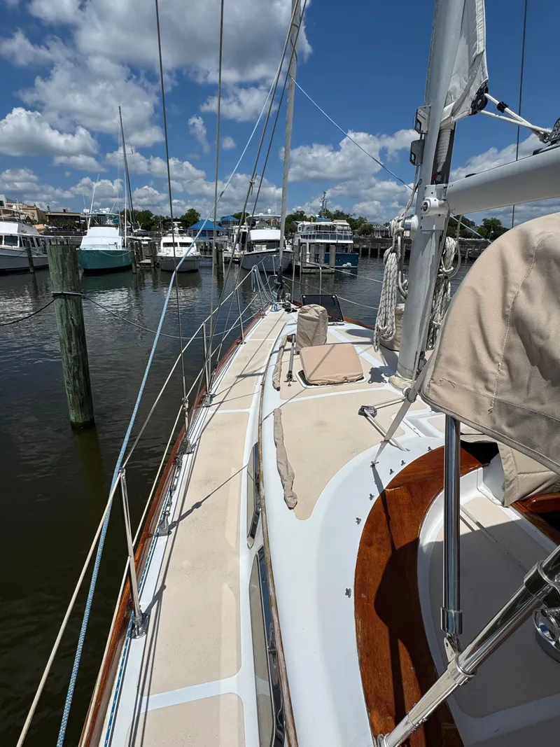 Slide: The Image of 1981 Gulfstar 44 sailboat docked at marina under blue sky. - 14