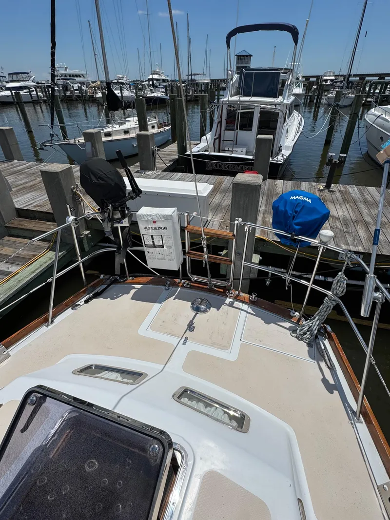 Slide: The Image of 1981 Gulfstar 44 sailboat docked at a marina, surrounded by other boats. - 15