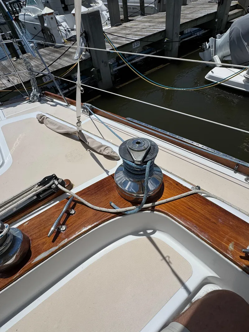 Slide: The Image of 1981 Gulfstar 44 sailboat deck with winch and ropes at marina. - 17