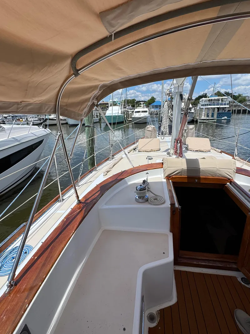 Slide: The Image of 1981 Gulfstar 44 sailboat cockpit with canopy, docked at marina. - 19