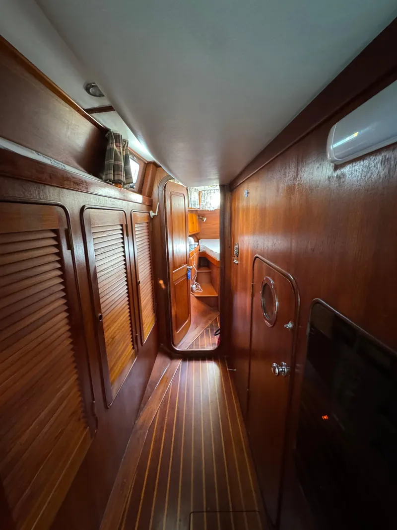 Slide: The Image of Interior of 1981 Gulfstar 44 yacht with wooden paneling and narrow hallway. - 23