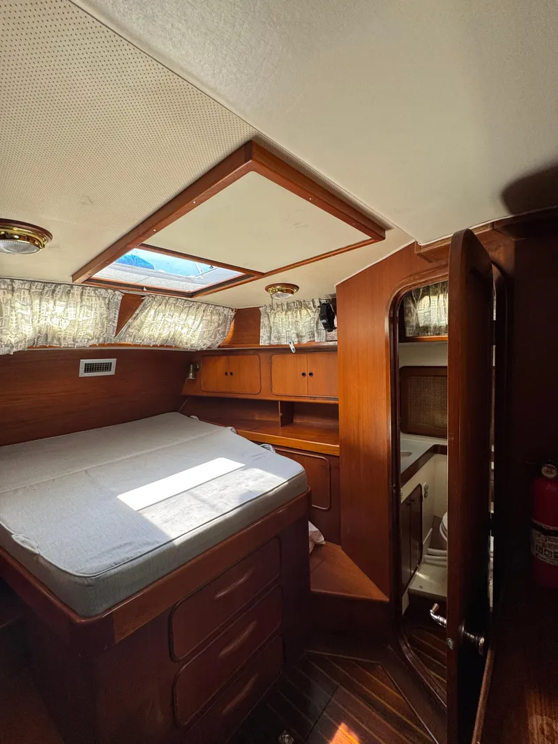 Slide: The Image of 1981 Gulfstar 44 yacht interior with wood finish, bed, and skylight. - 24