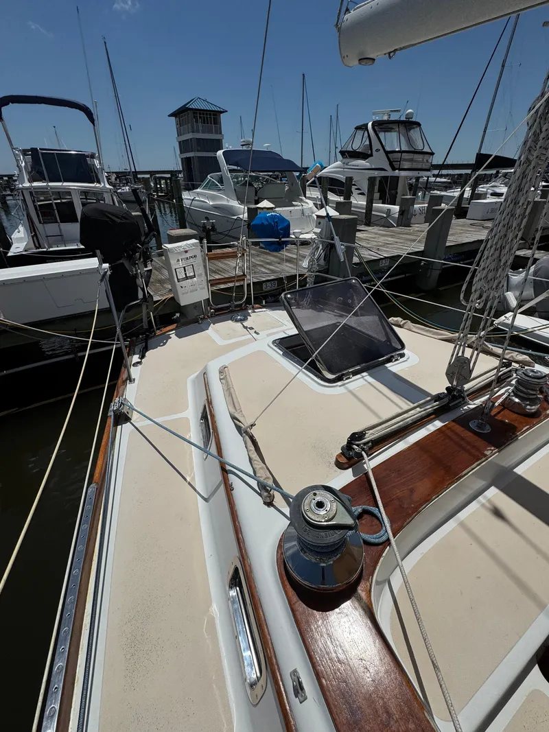 Slide: The Image of 1981 Gulfstar 44 sailboat docked at marina, surrounded by other boats. - 3