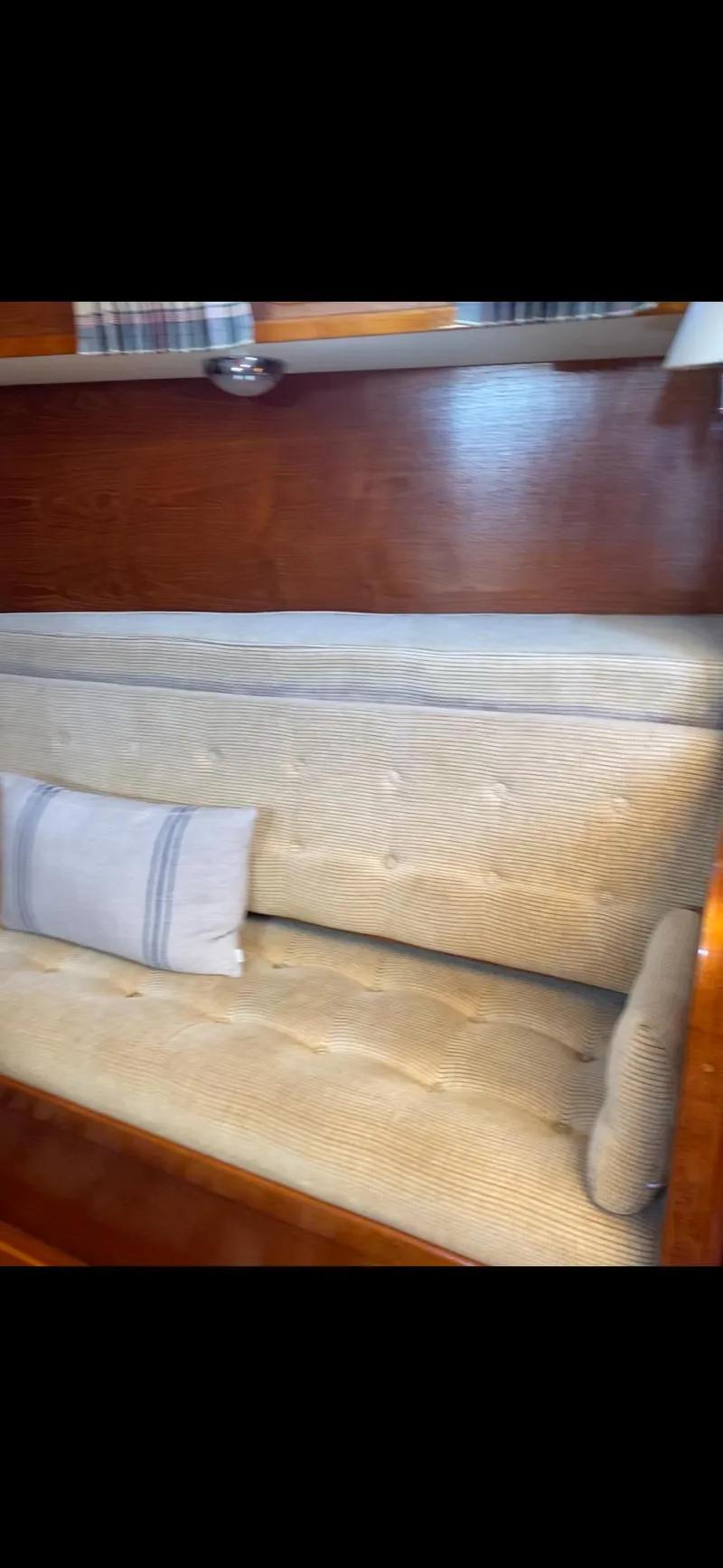 Slide: The Image of Interior of 1981 Gulfstar 44 yacht with cushioned seating and wooden paneling. - 30