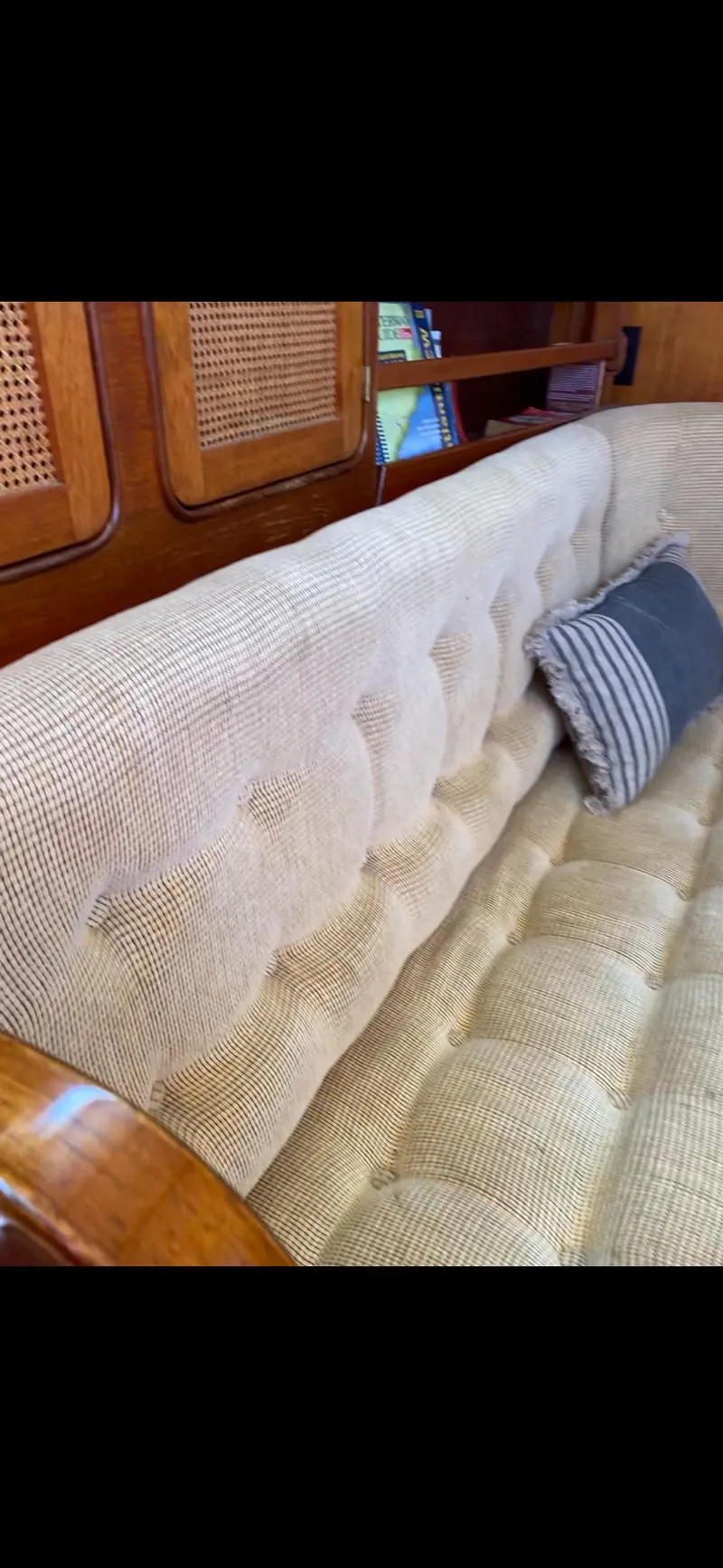 Slide: The Image of 1981 Gulfstar 44 yacht interior with beige tufted seating and striped pillow. - 32