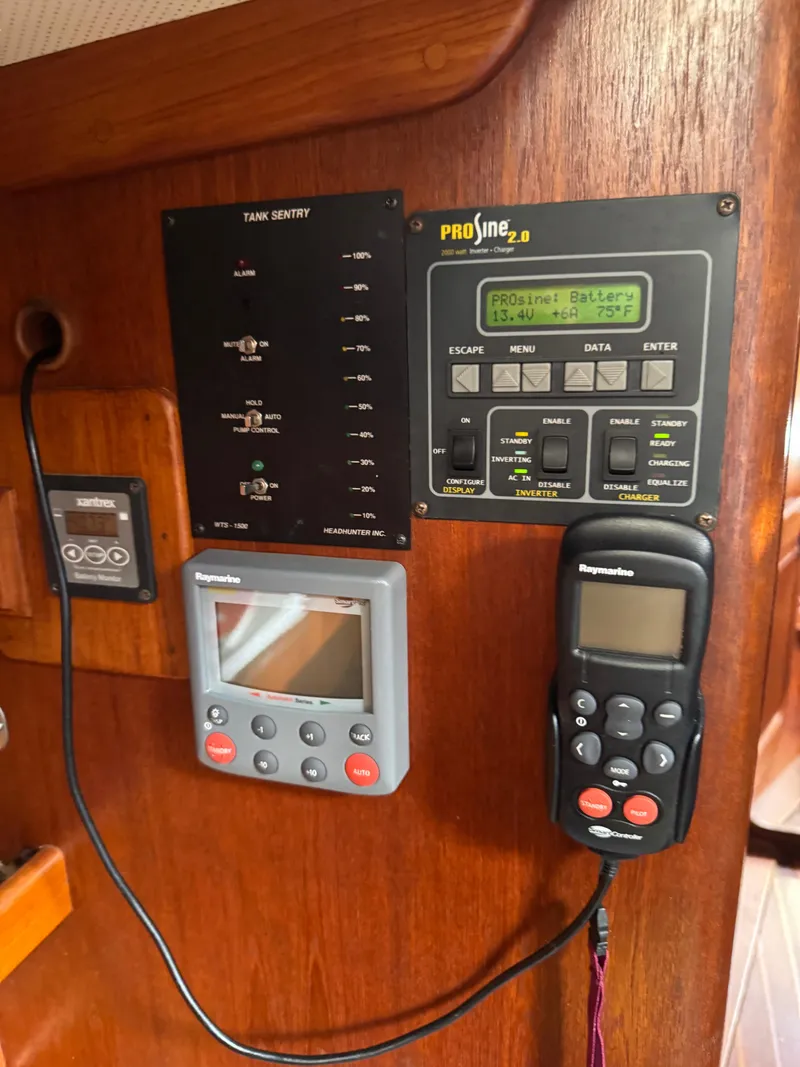 Slide: The Image of Control panel on a 1981 Gulfstar 44 yacht, featuring navigation and monitoring equipment. - 36