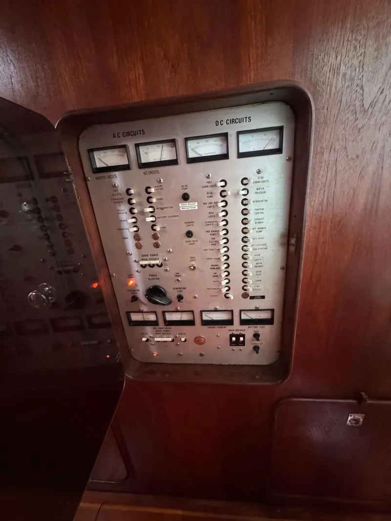 Slide: The Image of Control panel of a 1981 Gulfstar 44 yacht, featuring AC and DC circuits. - 40