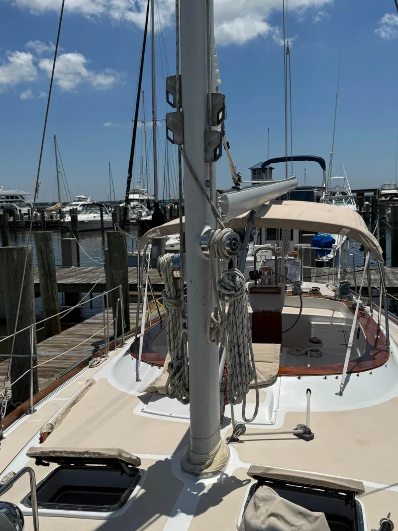 Slide: The Image of 1981 Gulfstar 44 sailboat docked at marina under clear blue sky. - 6