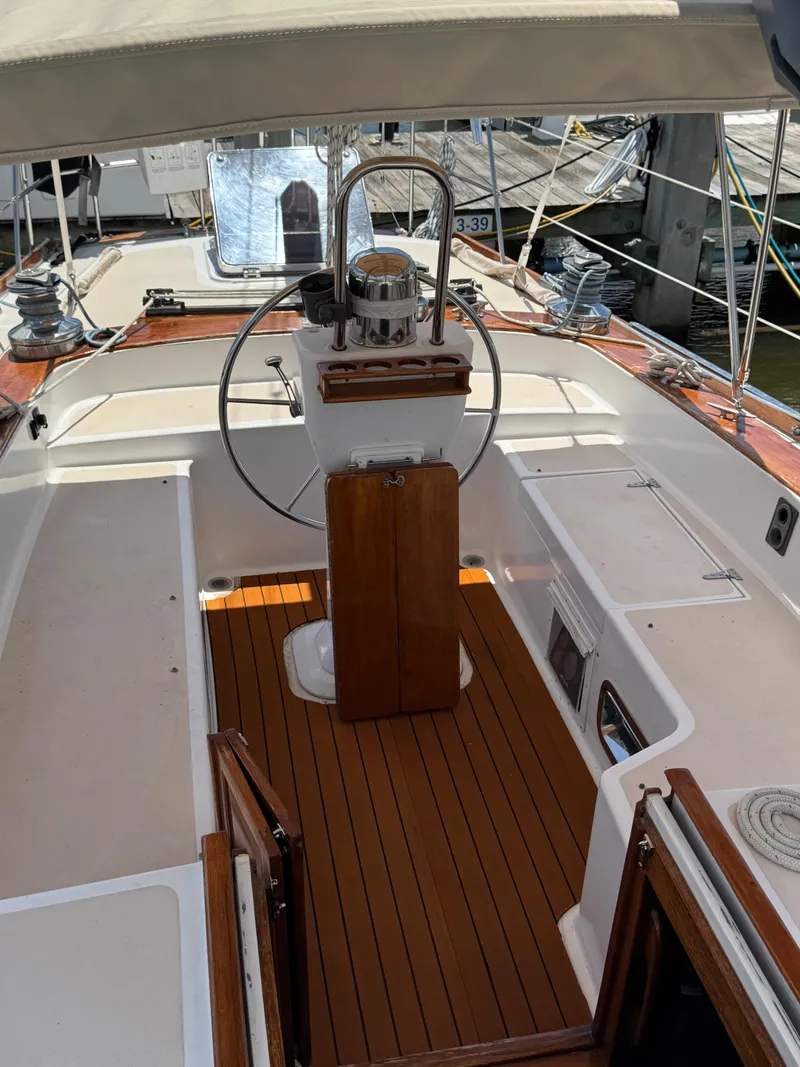 Slide: The Image of 1981 Gulfstar 44 sailboat cockpit with wooden flooring and steering wheel. - 7