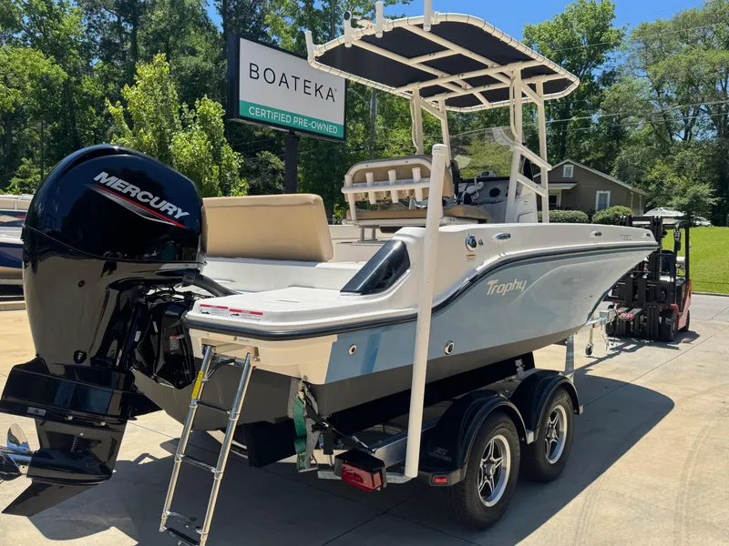 Slide: The Image of 2022 Bayliner Trophy T20CC boat on trailer, featuring Mercury engine, at Boateka dealership. - 2