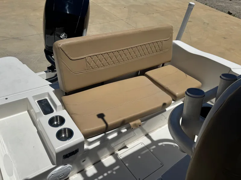 Slide: The Image of 2022 Bayliner Trophy T20CC boat interior with tan seating and cup holders. - 4