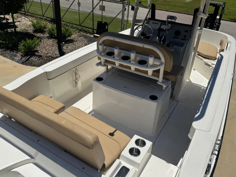 Slide: The Image of 2022 Bayliner Trophy T20CC boat interior with beige seating and steering console. - 7