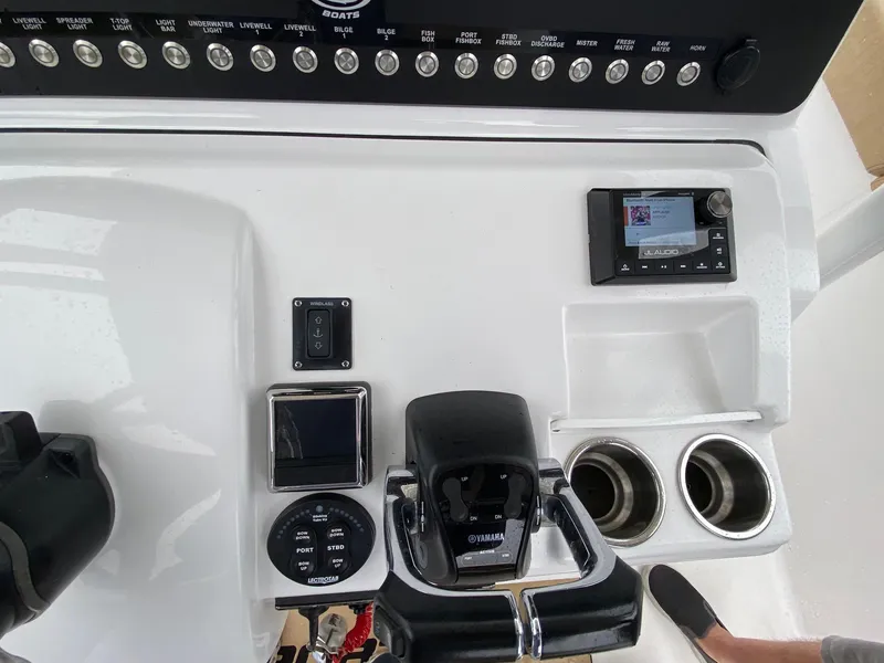 Slide: The Image of 2018 Sportsman Heritage 251 Center Console dashboard with controls and cup holders. - 10