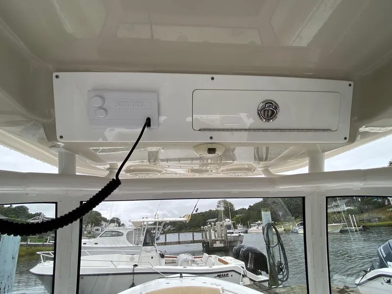 Slide: The Image of 2018 Sportsman Heritage 251 Center Console boat interior with control panel and storage. - 20