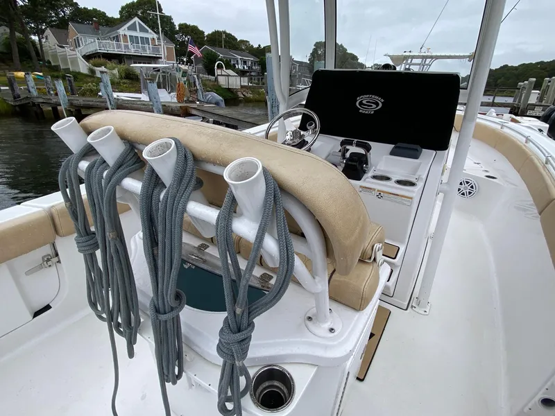 Slide: The Image of 2018 Sportsman Heritage 251 Center Console boat with fishing rod holders and ropes. - 22
