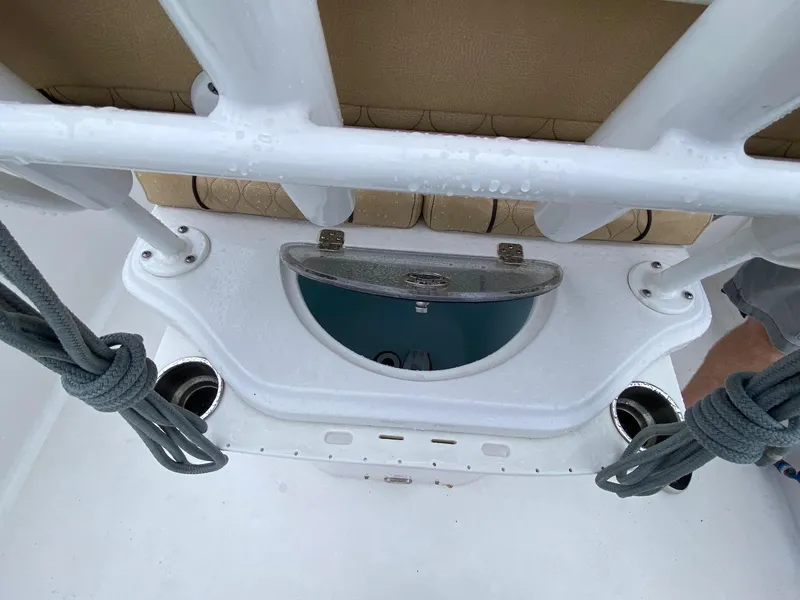 Slide: The Image of 2018 Sportsman Heritage 251 Center Console boat interior with storage compartment and cup holders. - 23