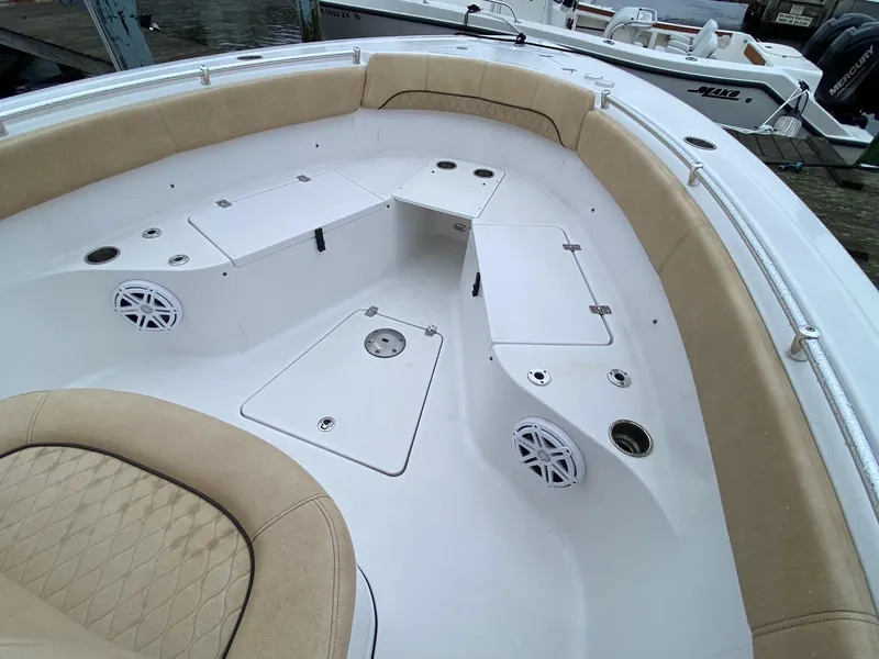 Slide: The Image of 2018 Sportsman Heritage 251 Center Console boat interior with cushioned seating and storage compartments. - 25