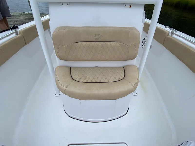 Slide: The Image of 2018 Sportsman Heritage 251 Center Console boat seating with beige cushions. - 26