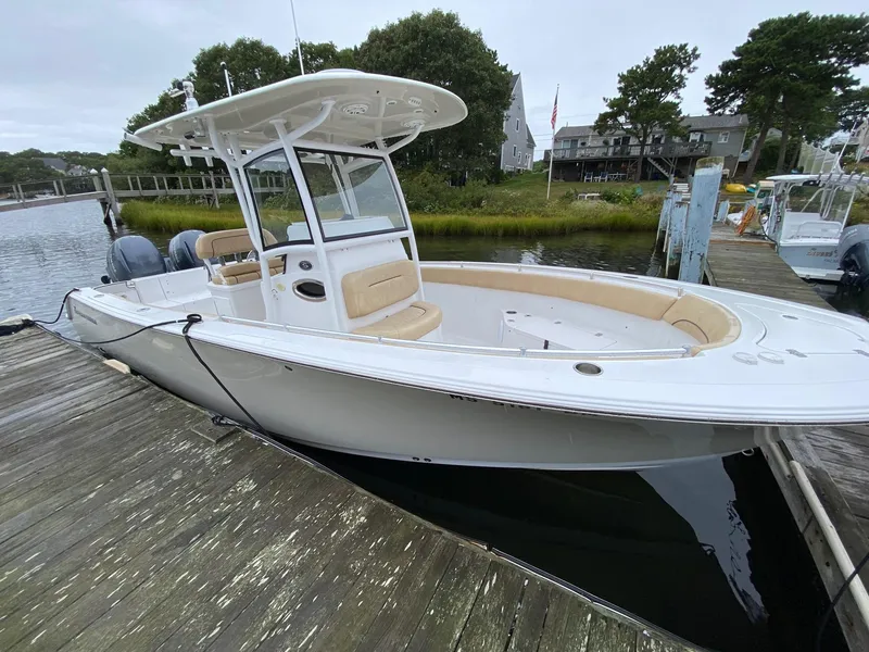 Slide: The Image of 2018 Sportsman Heritage 251 Center Console boat docked by a scenic waterfront. - 3