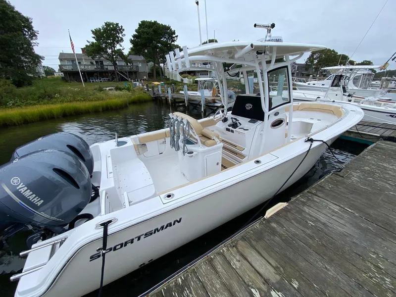 Slide: The Image of 2018 Sportsman Heritage 251 Center Console boat docked with twin Yamaha engines. - 4