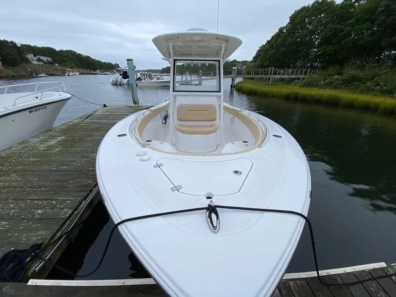 Slide: The Image of 2018 Sportsman Heritage 251 Center Console boat docked by a scenic waterfront. - 5