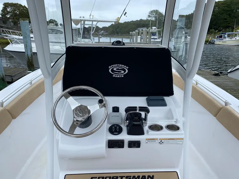 Slide: The Image of 2018 Sportsman Heritage 251 Center Console boat interior with steering wheel and controls. - 6