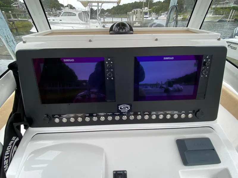 Slide: The Image of 2018 Sportsman Heritage 251 Center Console dashboard with dual Simrad displays. - 7
