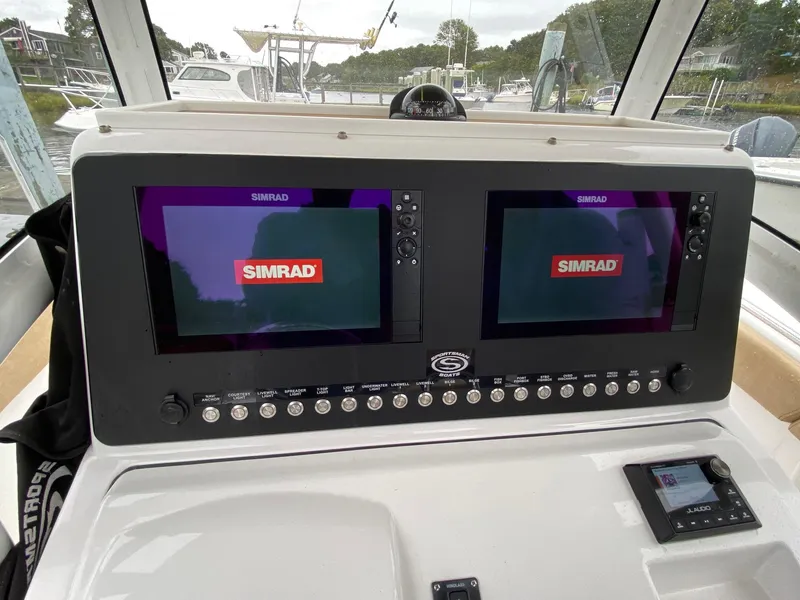 Slide: The Image of 2018 Sportsman Heritage 251 Center Console dashboard with dual Simrad displays. - 8