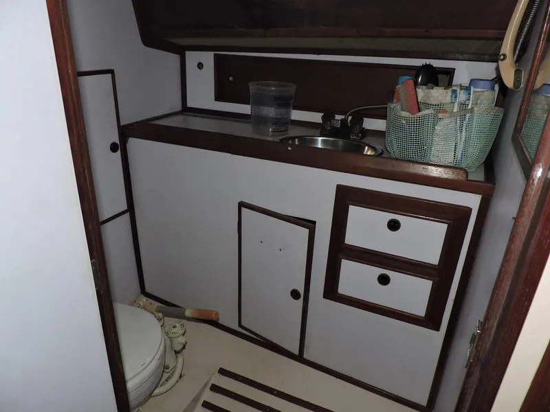 Slide: The Image of Bathroom interior of 1982 Custom Wings 33 Ketch sailboat, featuring sink and storage. - 10