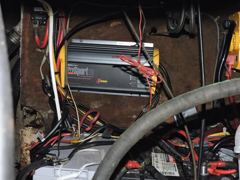 Slide: The Image of Electrical wiring and battery setup inside a 1982 Custom Wings 33 Ketch sailboat. - 13