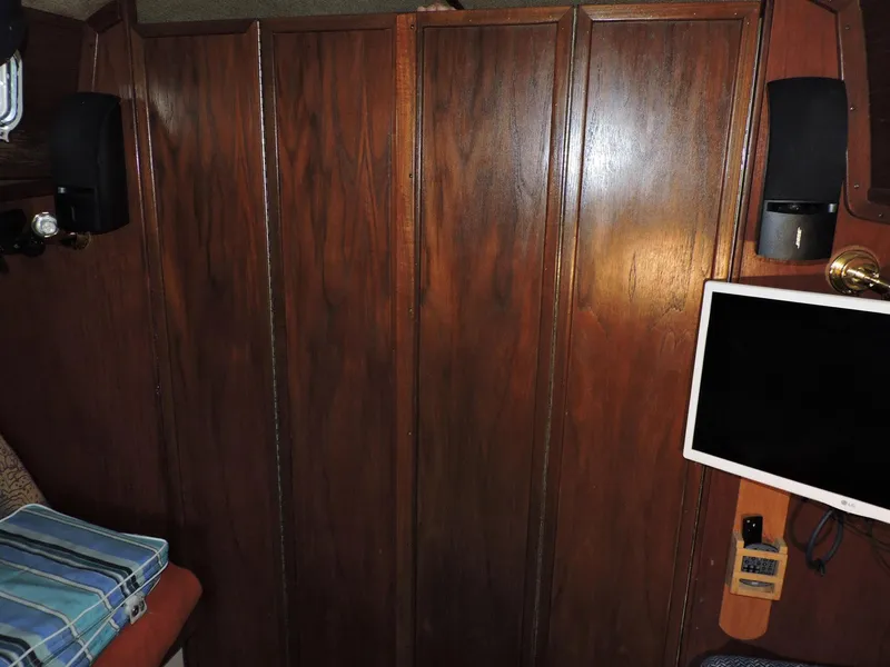 Slide: The Image of Interior of 1982 Custom Wings 33 Ketch with wood paneling and mounted screen. - 7
