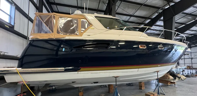 Slide: The Image of 2004 Tiara Yachts 3600 Sovran in a warehouse, elevated on stands. - 1