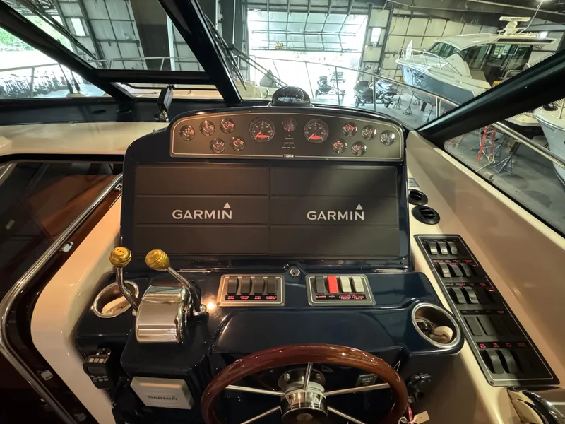 Slide: The Image of 2004 Tiara Yachts 3600 Sovran helm with Garmin navigation displays in a marina setting. - 13