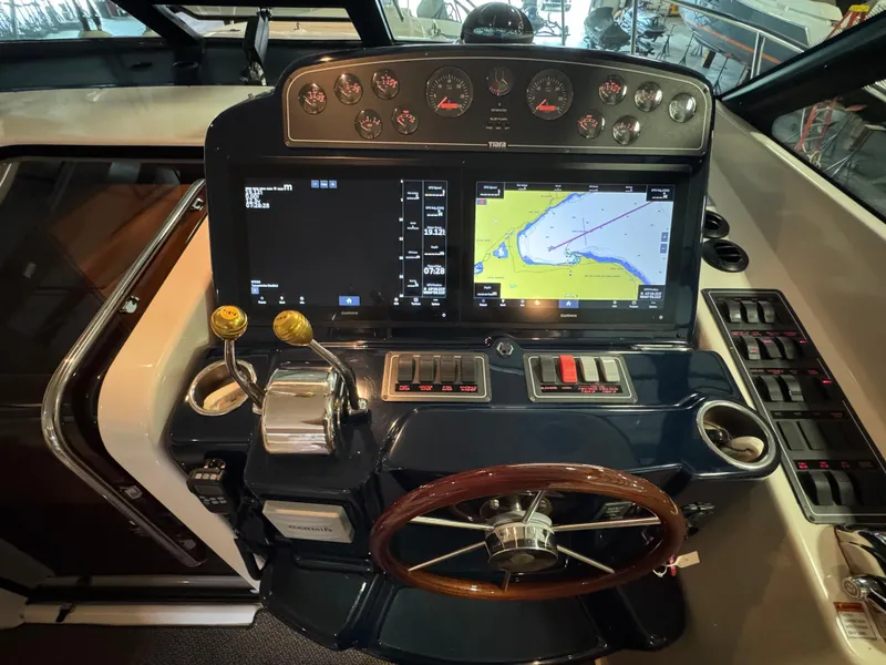Slide: The Image of 2004 Tiara Yachts 3600 Sovran helm with navigation screens and controls. - 14