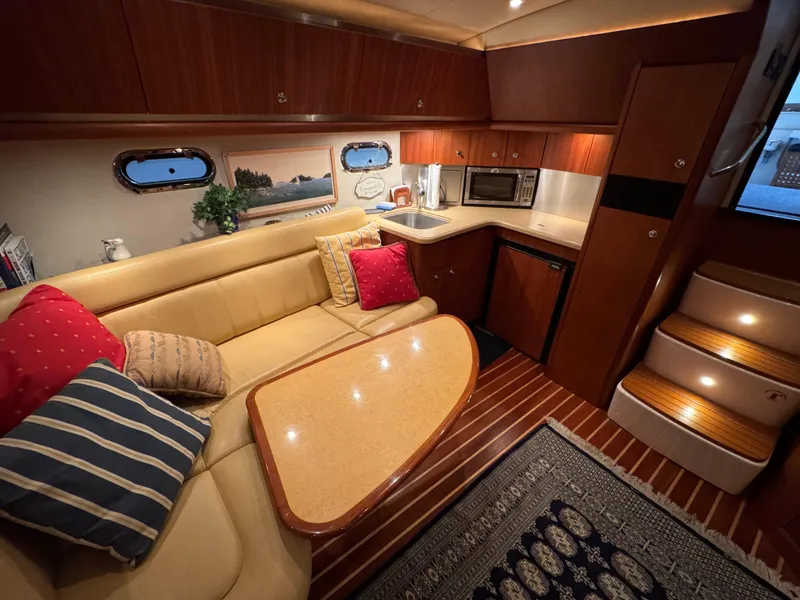 Slide: The Image of 2004 Tiara Yachts 3600 Sovran interior with cozy seating, kitchenette, and elegant wood finishes. - 17