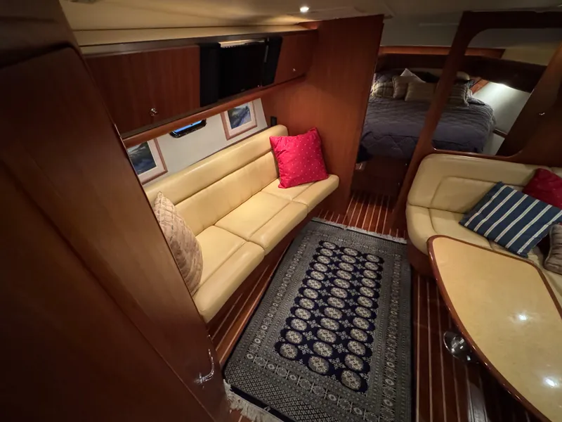 Slide: The Image of 2004 Tiara Yachts 3600 Sovran interior with cozy seating, elegant decor, and a stylish rug. - 19