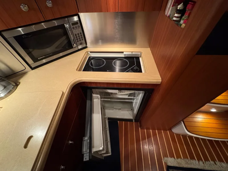 Slide: The Image of 2004 Tiara Yachts 3600 Sovran galley with microwave, stove, and refrigerator. - 20