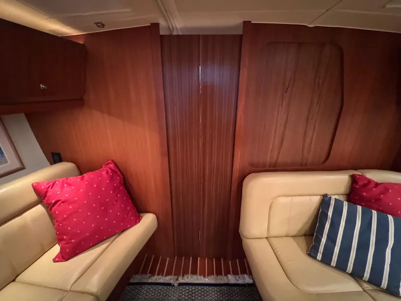Slide: The Image of Interior of 2004 Tiara Yachts 3600 Sovran with beige seating and colorful cushions. - 22