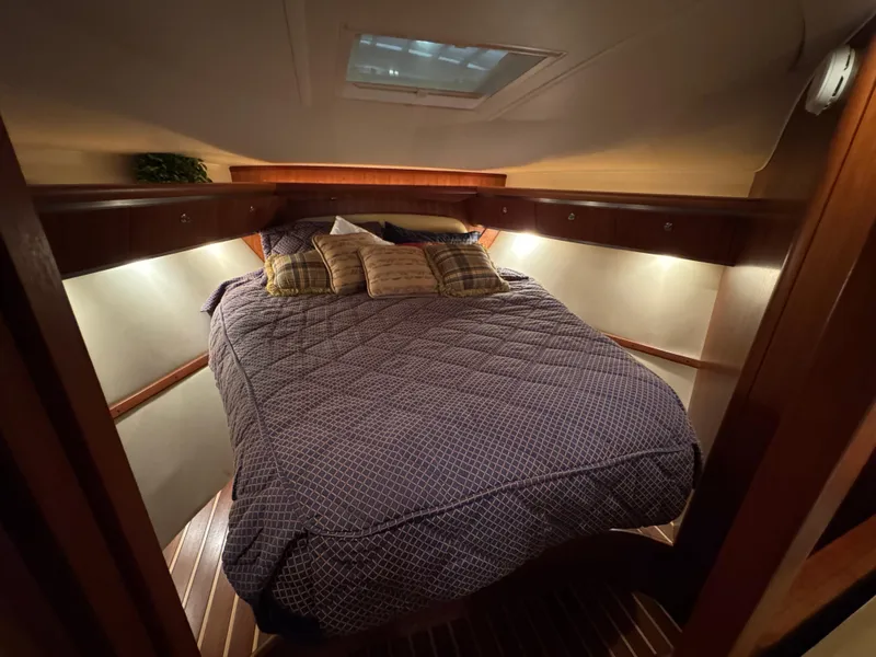 Slide: The Image of 2004 Tiara Yachts 3600 Sovran cabin with cozy bed and ambient lighting. - 23