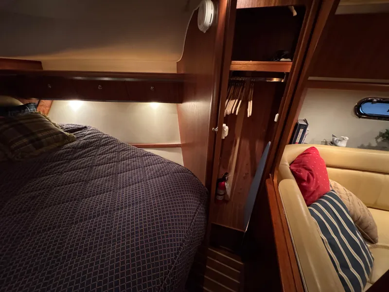 Slide: The Image of 2004 Tiara Yachts 3600 Sovran cabin interior with bed, closet, and seating area. - 24
