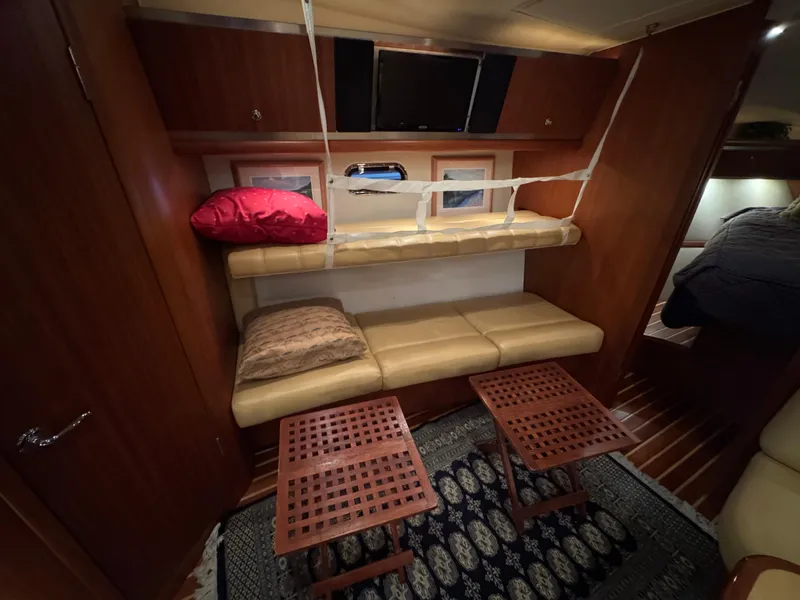 Slide: The Image of 2004 Tiara Yachts 3600 Sovran interior with seating, tables, and wooden cabinetry. - 26